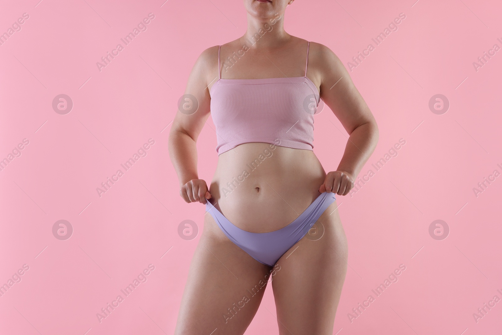 Liposuction. Woman in underwear on pink background, closeup Photo of Liposuction. Woman in underwear on pink background, closeup