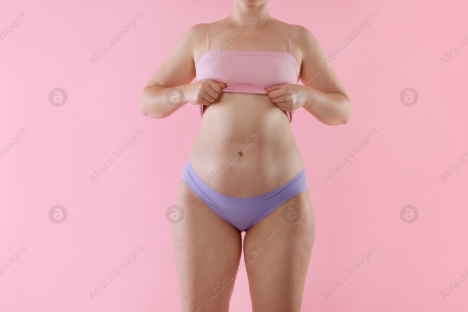 Photo of Liposuction. Woman in underwear on pink background, closeup