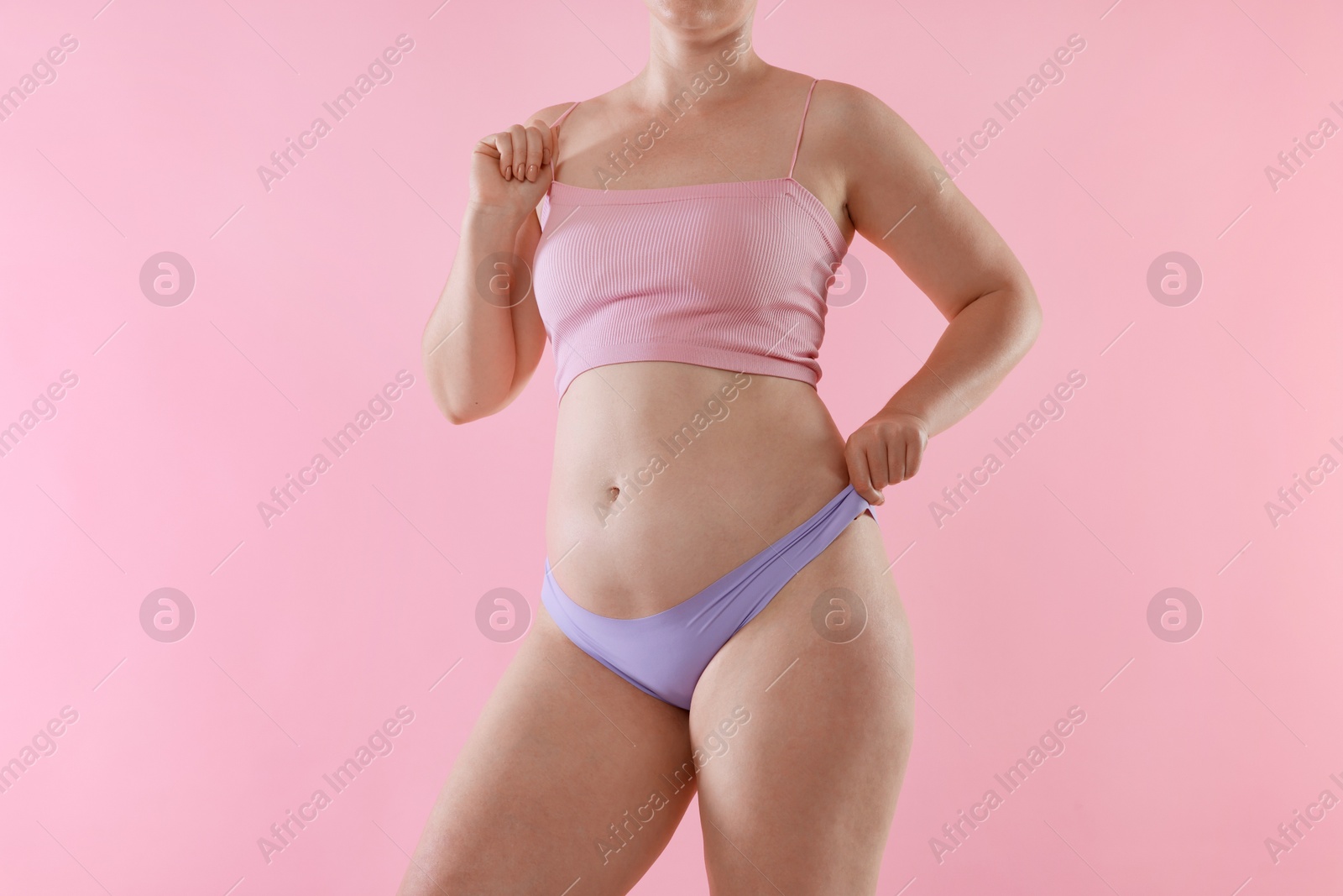 Photo of Liposuction. Woman in underwear on pink background, closeup