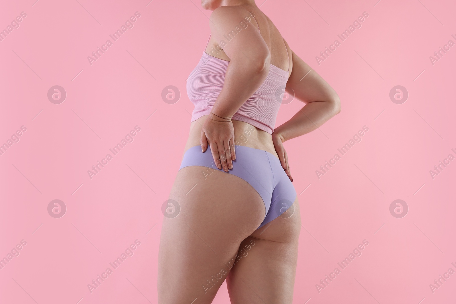 Liposuction. Woman in underwear on pink background, closeup Photo of Liposuction. Woman in underwear on pink background, closeup