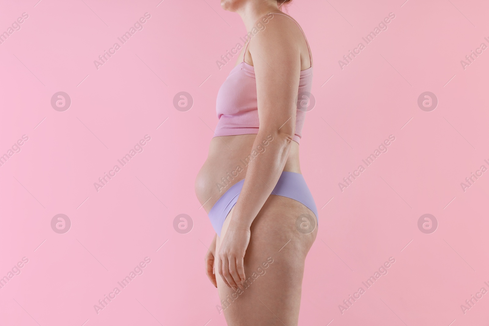 Photo of Liposuction. Woman in underwear on pink background, closeup