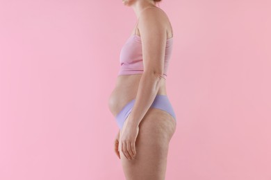Photo of Liposuction. Woman in underwear on pink background, closeup