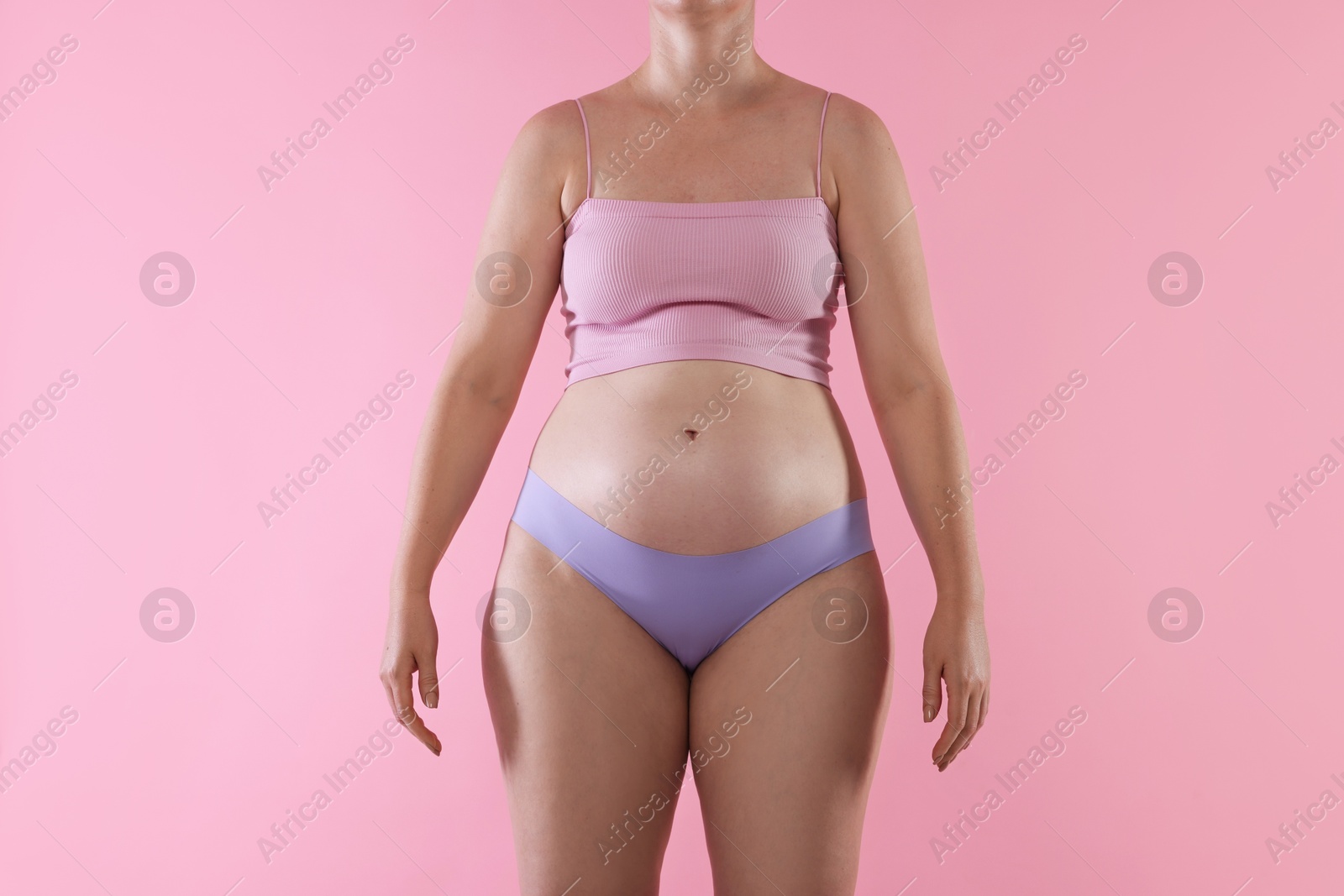 Photo of Liposuction. Woman in underwear on pink background, closeup