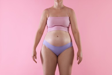 Photo of Liposuction. Woman in underwear on pink background, closeup