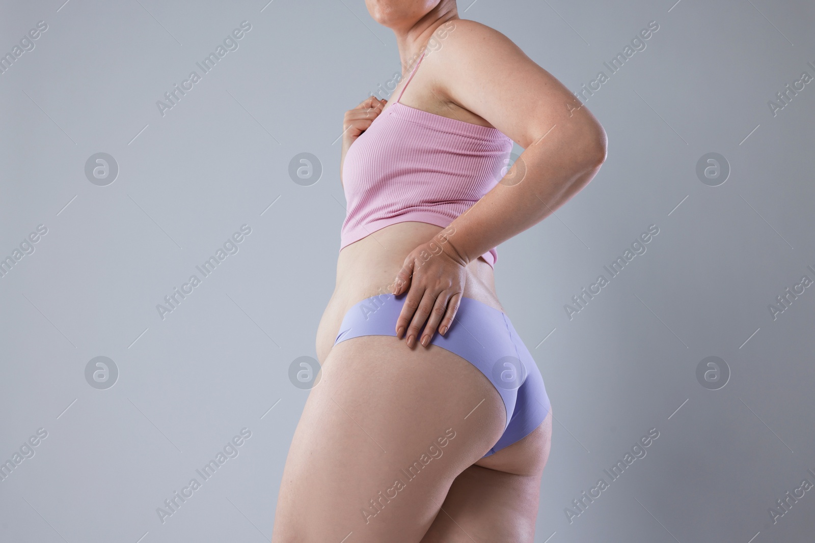 Liposuction. Woman in underwear on grey background, closeup Photo of Liposuction. Woman in underwear on grey background, closeup