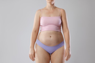 Photo of Liposuction. Woman in underwear on grey background, closeup