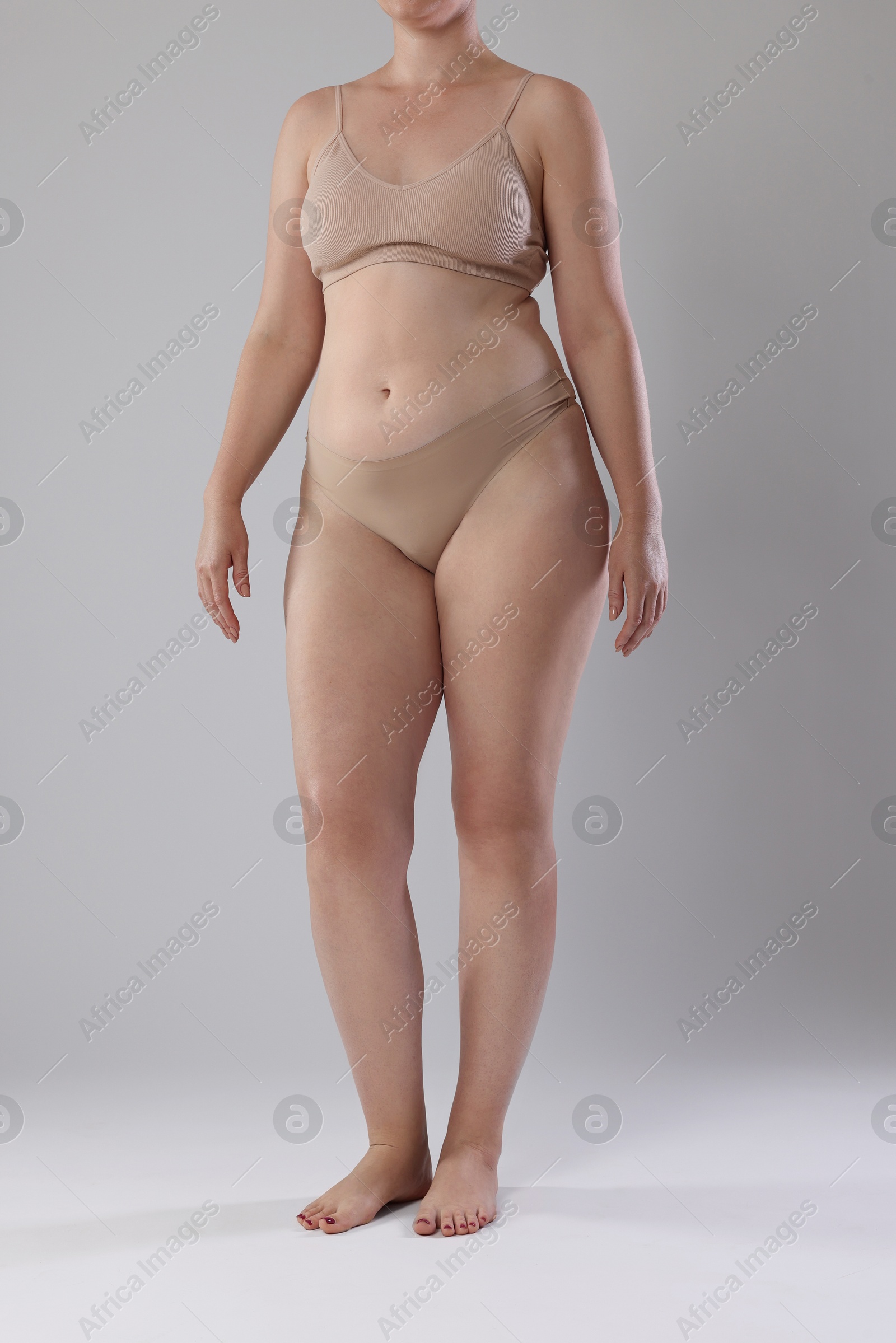 Photo of Liposuction. Woman in underwear on grey background, closeup