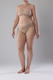 Photo of Liposuction. Woman in underwear on grey background, closeup