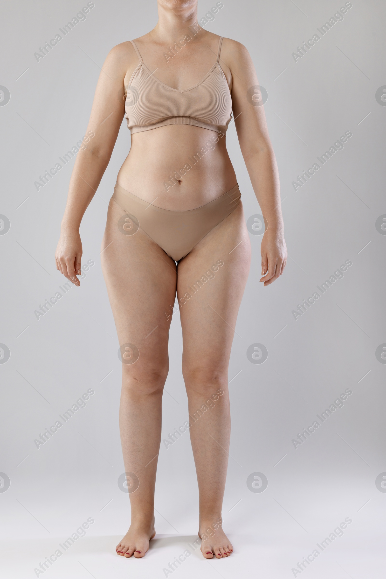 Liposuction. Woman in underwear on grey background, closeup Photo of Liposuction. Woman in underwear on grey background, closeup