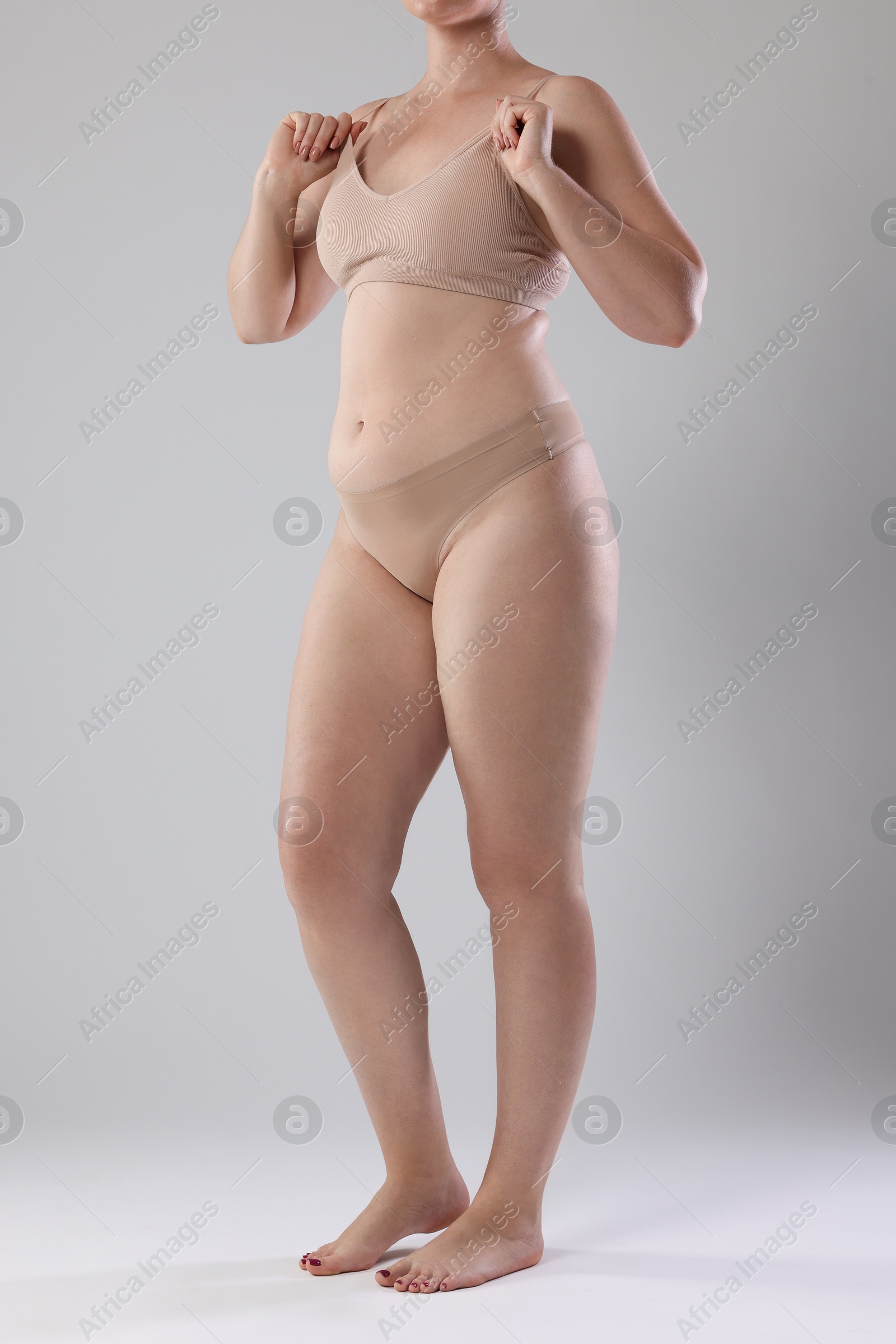 Liposuction. Woman in underwear on grey background, closeup Photo of Liposuction. Woman in underwear on grey background, closeup