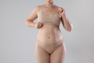 Photo of Liposuction. Woman in underwear on grey background, closeup