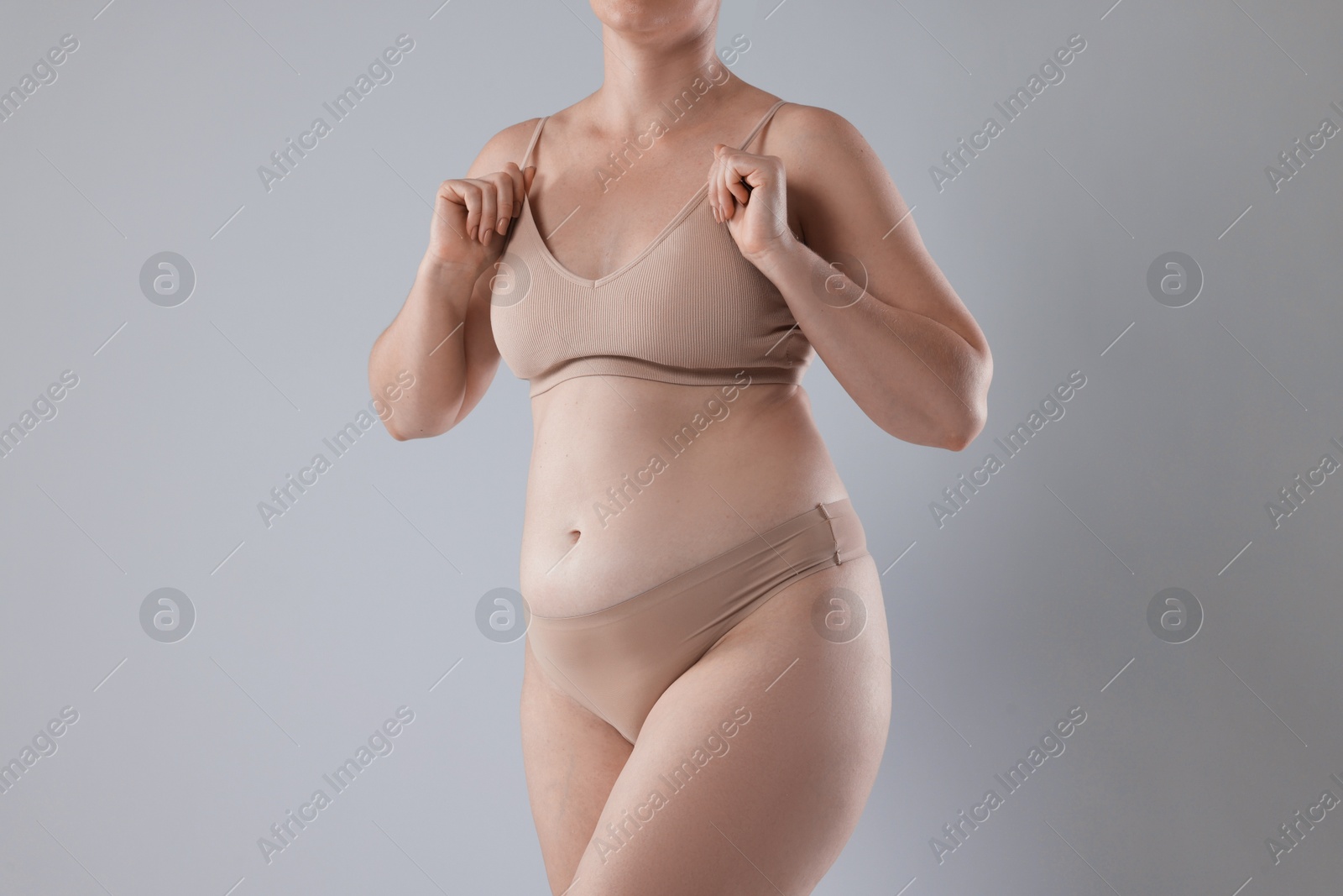 Photo of Liposuction. Woman in underwear on grey background, closeup