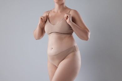Photo of Liposuction. Woman in underwear on grey background, closeup