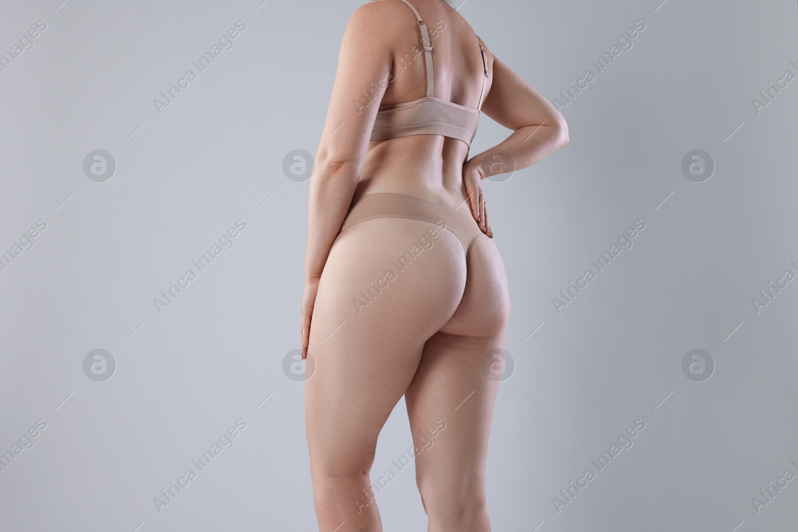 Photo of Liposuction. Woman in underwear on grey background, closeup
