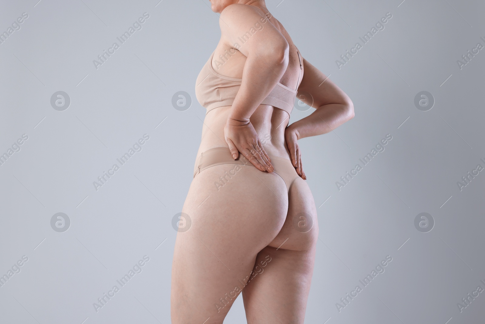 Photo of Liposuction. Woman in underwear on grey background, closeup