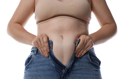 Photo of Liposuction. Woman trying to put on tight jeans against white background, closeup