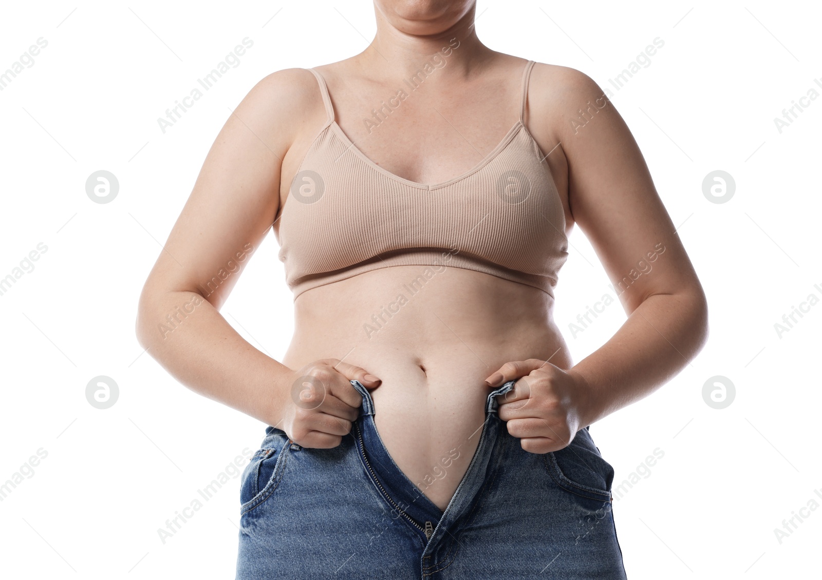 Liposuction. Woman trying to put on tight jeans against white background, closeup Photo of Liposuction. Woman trying to put on tight jeans against white background, closeup