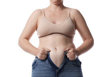 Photo of Liposuction. Woman trying to put on tight jeans against white background, closeup