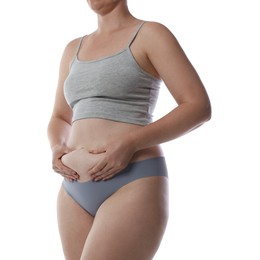 Photo of Liposuction. Woman in underwear touching her belly on white background, closeup