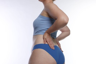 Photo of Liposuction. Woman in underwear on white background