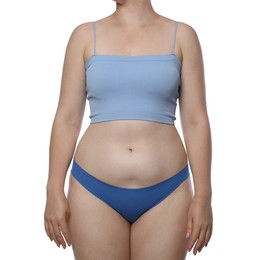 Photo of Liposuction. Woman in underwear touching her belly on white background, closeup