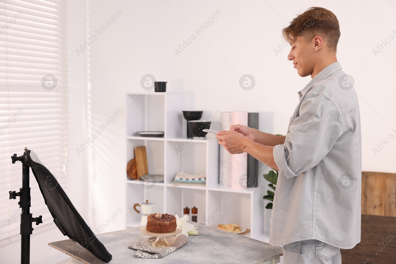 Man taking picture of chocolate cake in studio. Professional food photography Photo of Man taking picture of chocolate cake in studio. Professional food photography