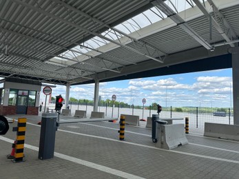 Photo of Malhowice-Nyzhankovychi, Ukraine, Poland - June 21, 2025: Border checkpoint with customs inspection booths