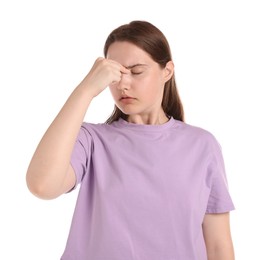 Photo of Young woman suffering from headache on white background