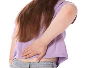 Photo of Young woman suffering from back pain on white background, closeup