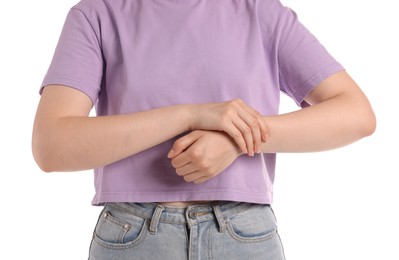 Photo of Young woman suffering from wrist pain on white background, closeup