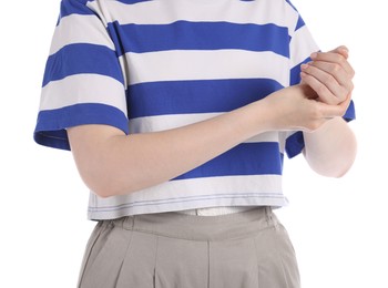 Photo of Young woman suffering from wrist pain on white background, closeup