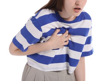 Photo of Young woman suffering from chest pain on white background, closeup
