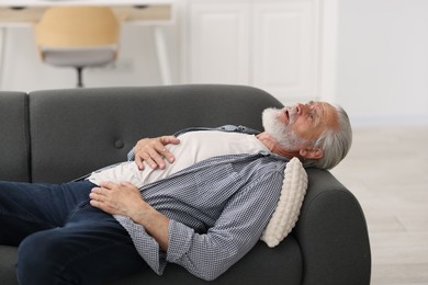 Photo of Senior man suffering from stomachache at home