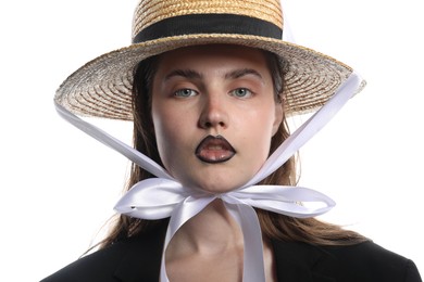 Photo of Beautiful young woman with black lip liner wearing straw hat on white background