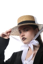 Photo of Beautiful young woman with black lip liner wearing straw hat on white background