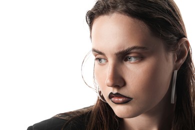 Photo of Beautiful young woman with black lip liner wearing stylish earrings on white background, closeup