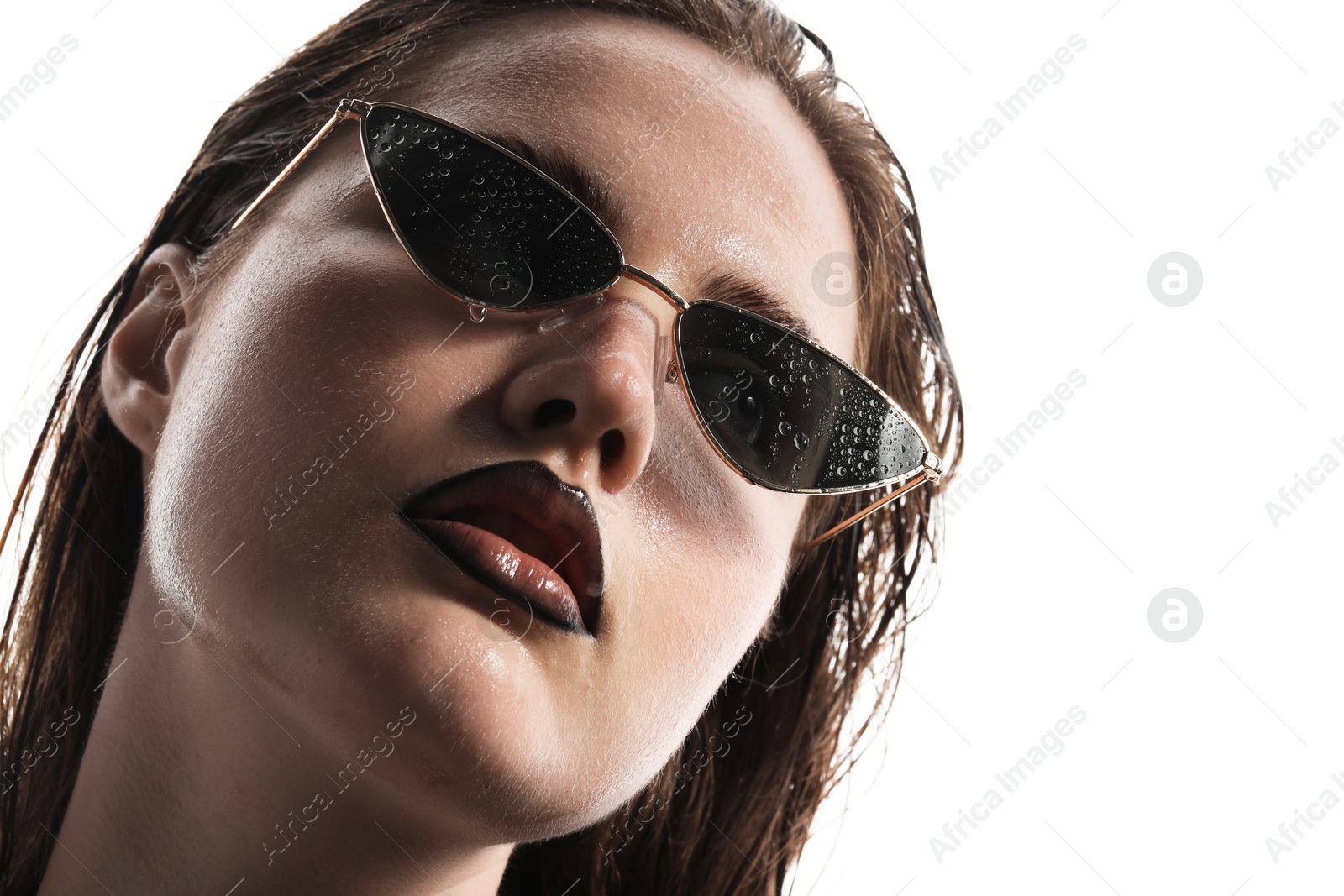 Beautiful young woman with black lip liner wearing wet sunglasses on white background, closeup Photo of Beautiful young woman with black lip liner wearing wet sunglasses on white background, closeup