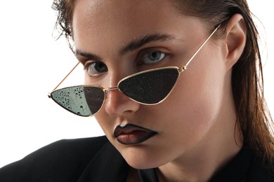 Photo of Beautiful young woman with black lip liner wearing wet sunglasses on white background, closeup