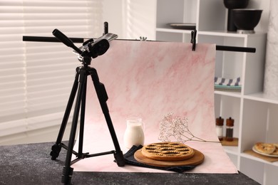 Photo of Shooting tasty pie and milk with smartphone in studio. Professional food photography