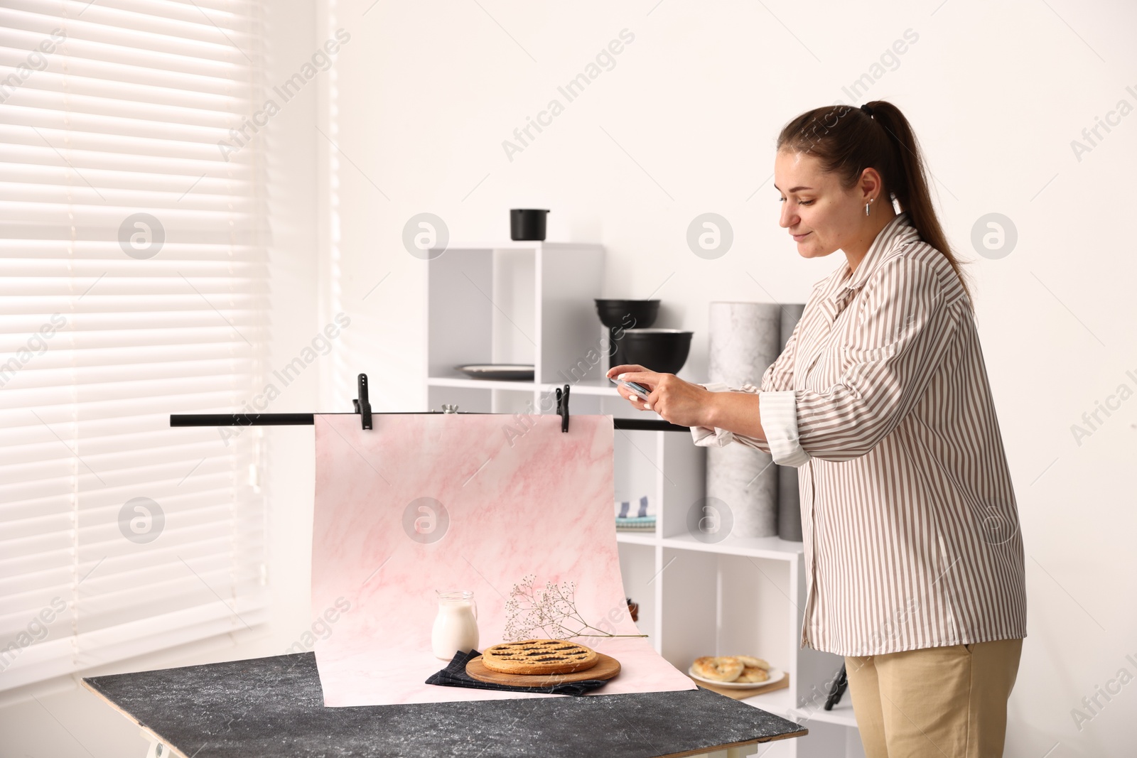 Woman taking picture of tasty pie and milk in studio. Professional food photography Photo of Woman taking picture of tasty pie and milk in studio. Professional food photography