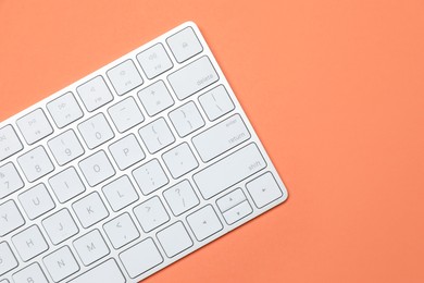 Photo of Modern white wireless keyboard on color background, top view. Space for text