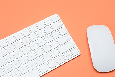Photo of Modern white wireless keyboard and mouse on color background, top view