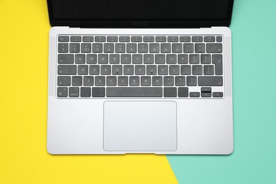 Photo of Modern laptop with keyboard on color background, top view
