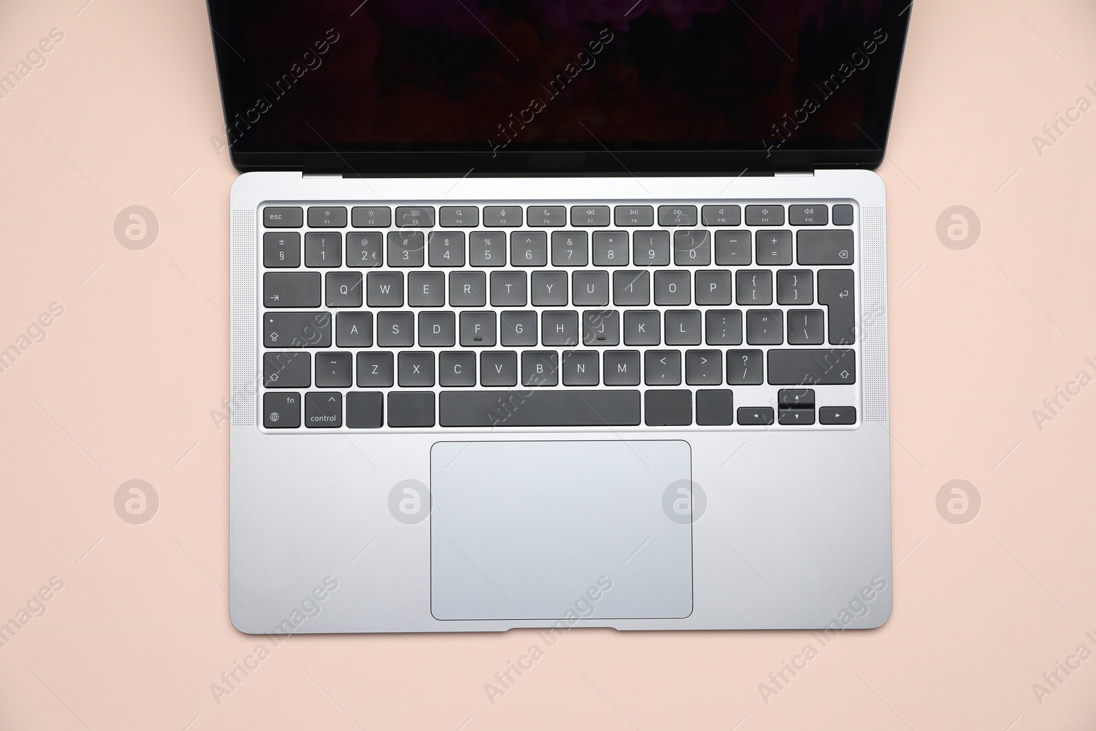 Modern laptop with keyboard on beige background, top view Photo of Modern laptop with keyboard on beige background, top view