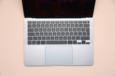 Photo of Modern laptop with keyboard on beige background, top view