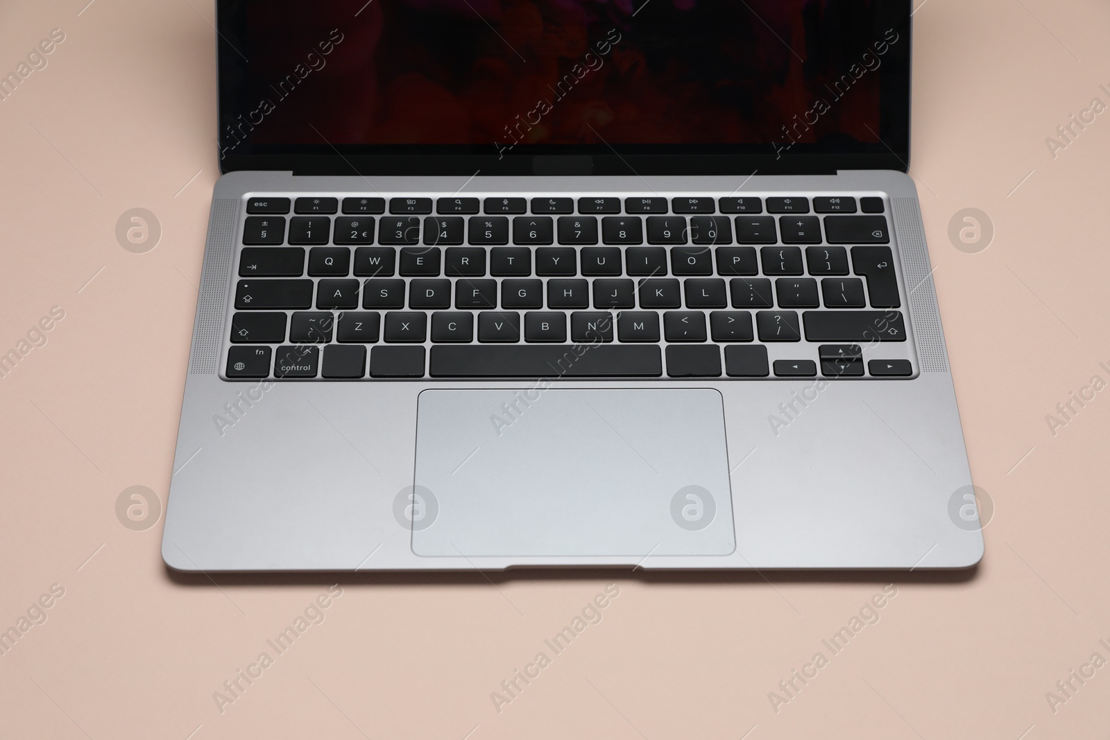 Modern laptop with keyboard on beige background, closeup Photo of Modern laptop with keyboard on beige background, closeup