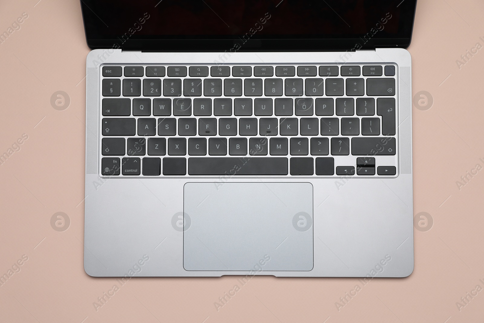 Modern laptop with keyboard on beige background, top view Photo of Modern laptop with keyboard on beige background, top view