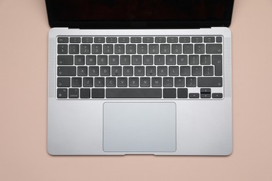 Photo of Modern laptop with keyboard on beige background, top view