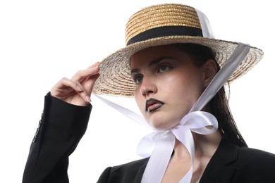 Photo of Beautiful young woman with black lip liner wearing straw hat on white background