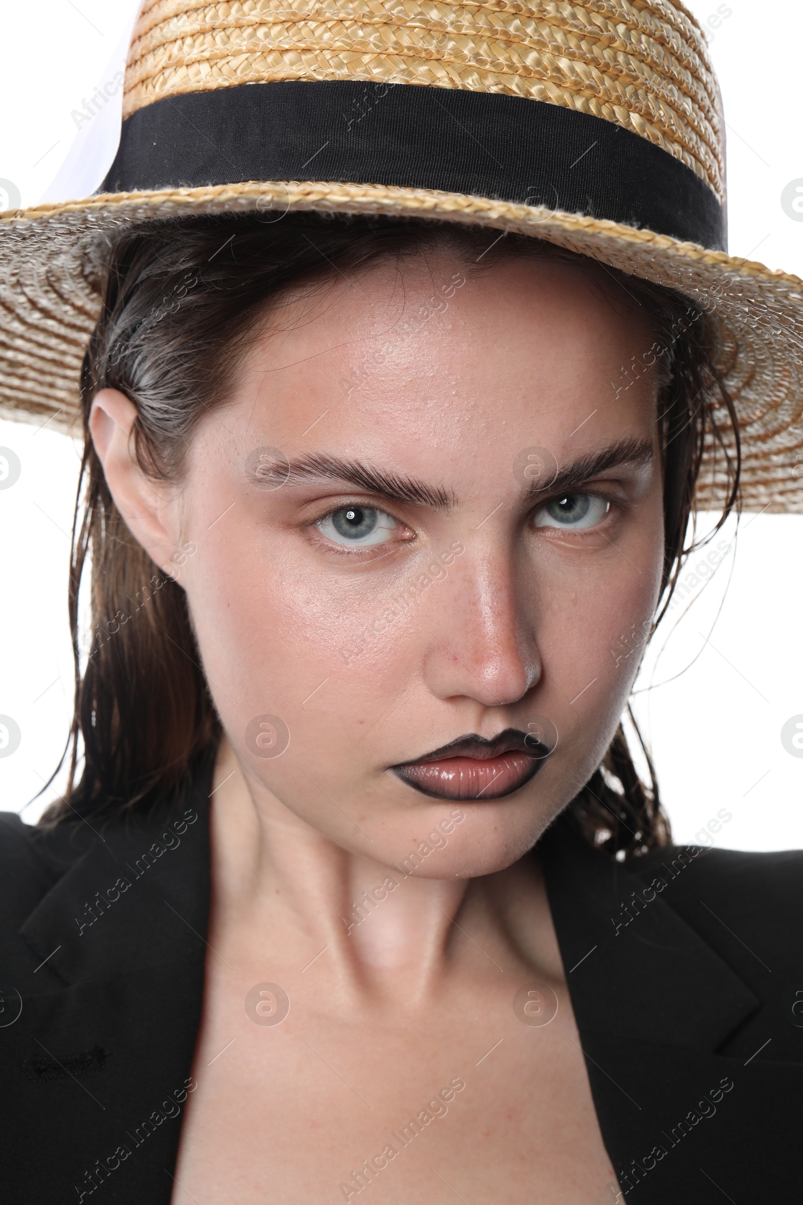 Beautiful young woman with black lip liner wearing straw hat on white background, closeup Photo of Beautiful young woman with black lip liner wearing straw hat on white background, closeup